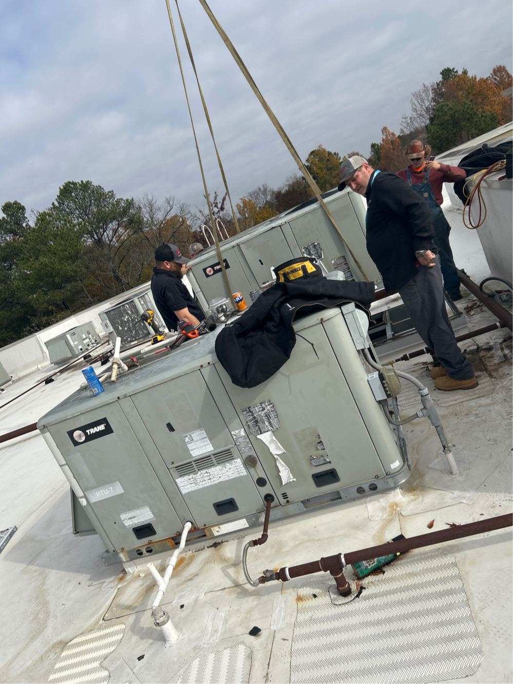 Crane setting a commercial rooftop HVAC unit for Comfortable LLC